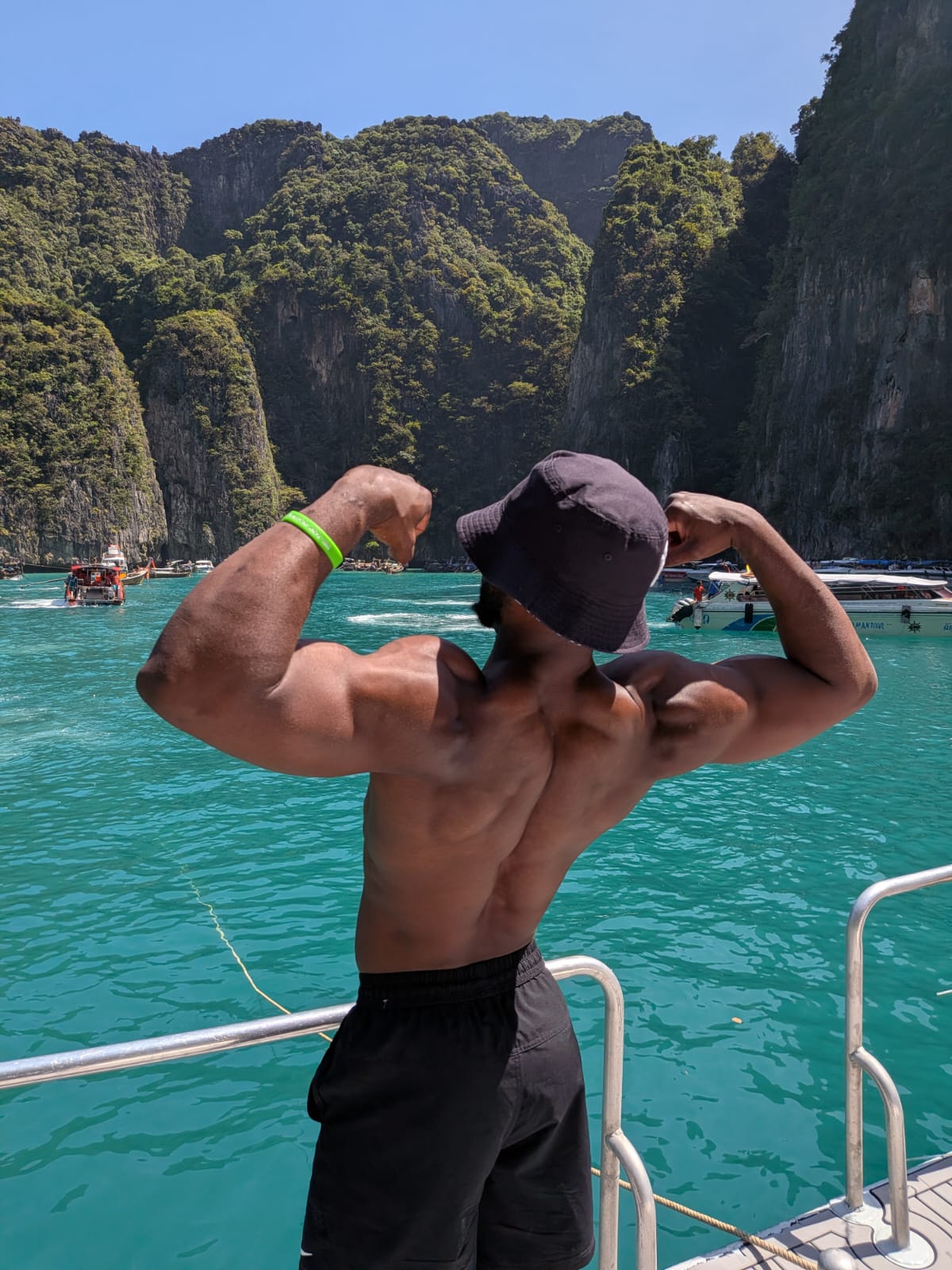 Farai Fitness coach outdoors with a strong back pose